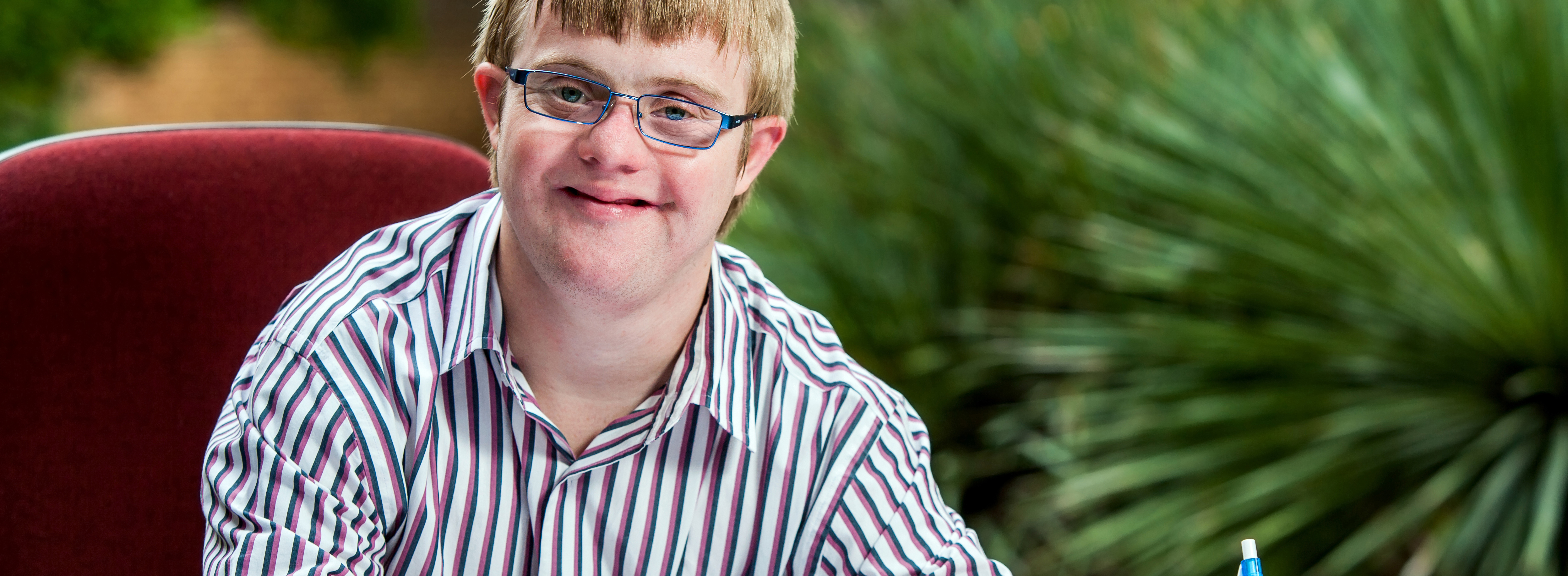 caucasian male with an intellectual disability working and smiling